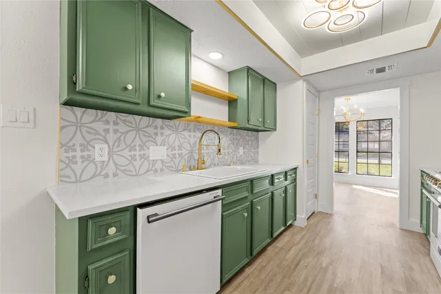 a kitchen with cabinets a sink and dishwasher