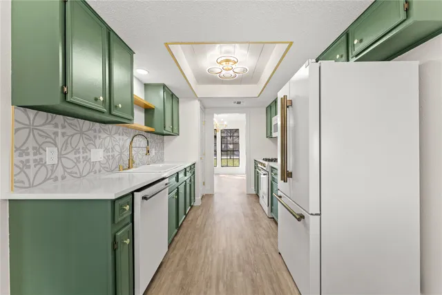 a kitchen with stainless steel appliances granite countertop a refrigerator and a sink