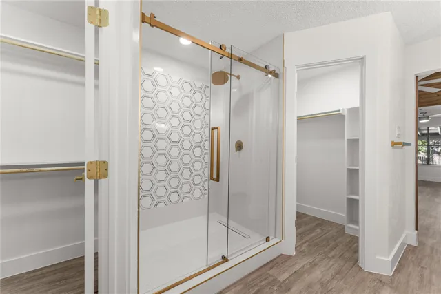 a bathroom with a glass shower door