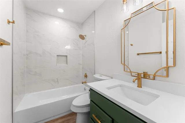 a bathroom with a sink toilet and shower