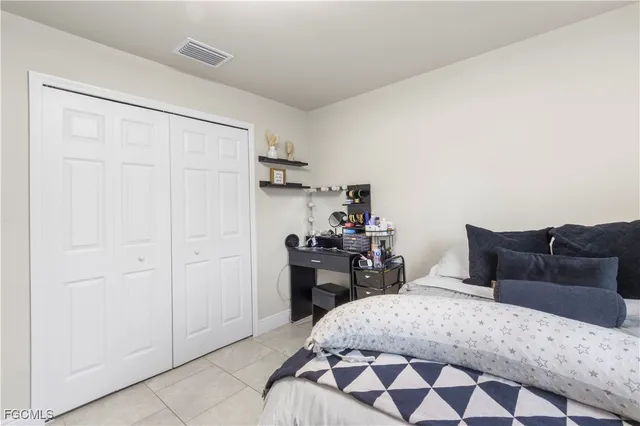 a bedroom with a bed and dresser