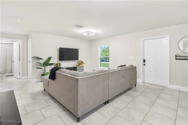 a living room with furniture and a flat screen tv