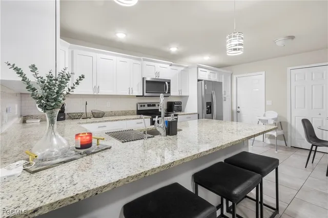 a kitchen with granite countertop a sink and a counter top space