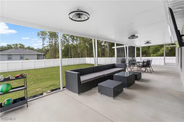 a building outdoor space with patio furniture and garden