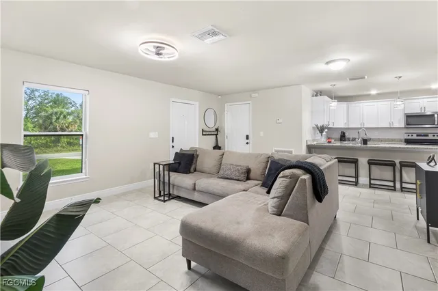 a living room with furniture and a large window