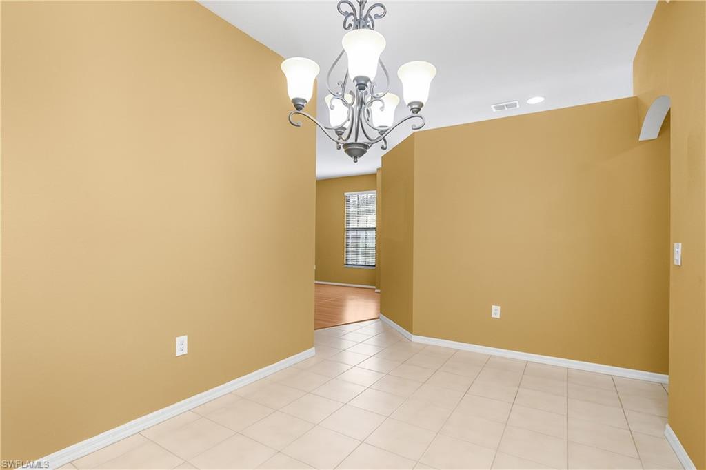 7820 Sandpine Court, Unit 2304 Naples, FL 34104 - Photo 15 of 50 a view of a livingroom with a chandelier