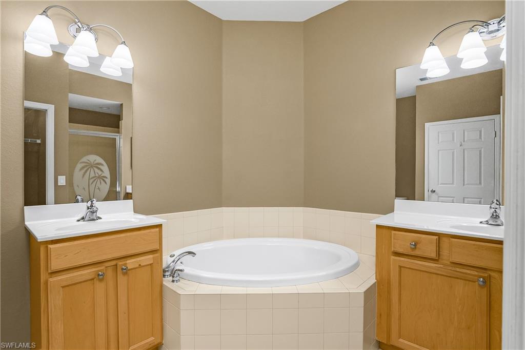 7820 Sandpine Court, Unit 2304 Naples, FL 34104 - Photo 21 of 50 a bathroom with a sink and a mirror