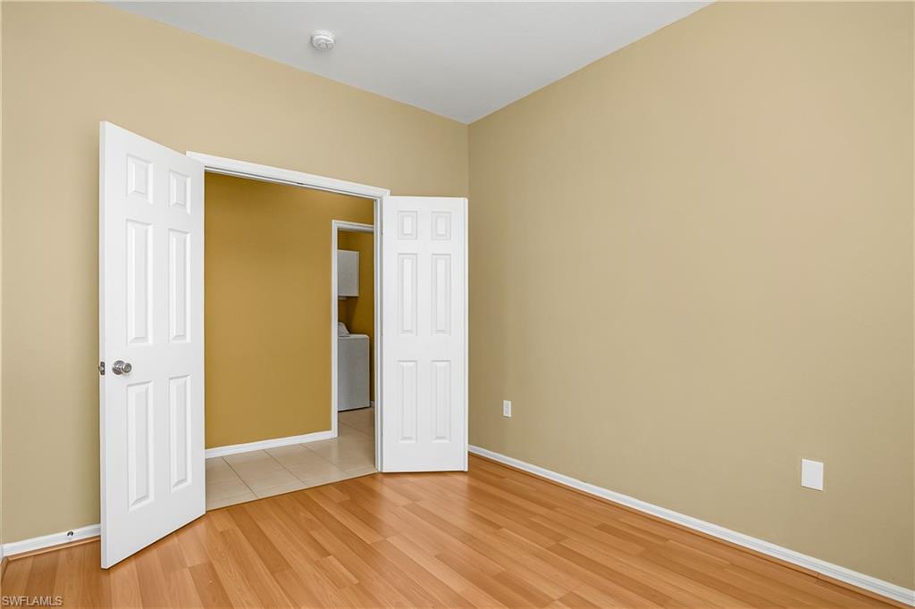 7820 Sandpine Court, Unit 2304 Naples, FL 34104 - Photo 27 of 50 a view of an empty room with wooden floor and closet