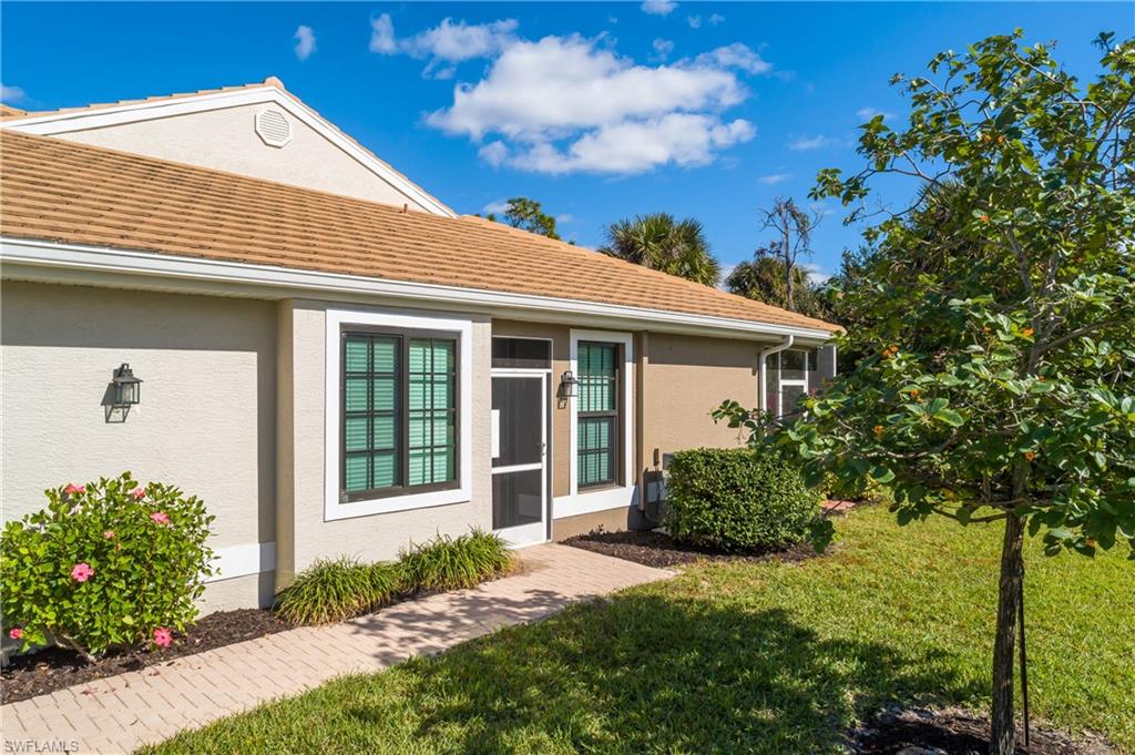 7820 Sandpine Court, Unit 2304 Naples, FL 34104 - Photo 33 of 50 a front view of a house with garden