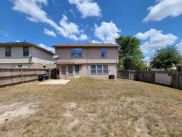 a view of a house with a backyard and fireplace