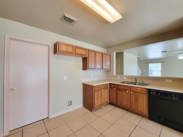 a kitchen with a sink and cabinets