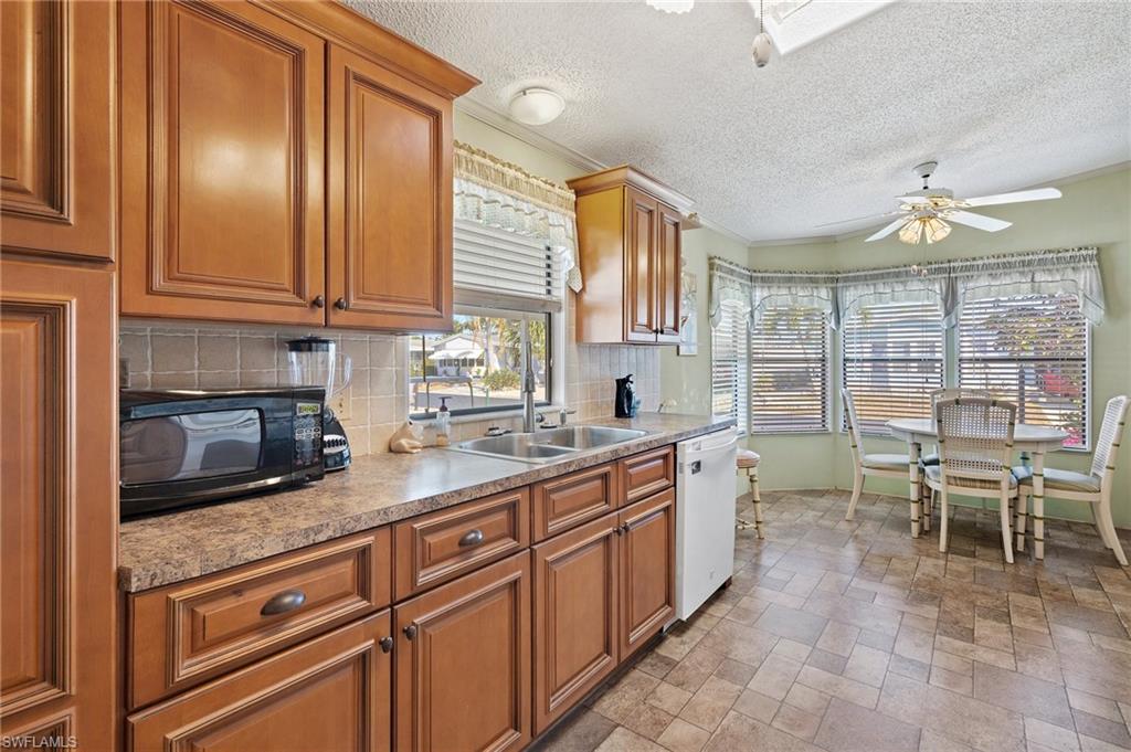 48 Oceans Boulevard, Unit 48 Naples, FL 34104 - Photo 13 of 26 a kitchen with sink cabinets and window