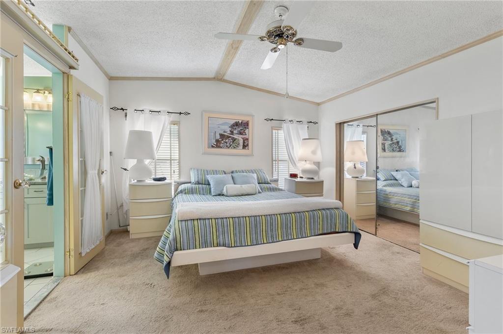 48 Oceans Boulevard, Unit 48 Naples, FL 34104 - Photo 14 of 26 a bedroom with a bed and a view of bathroom