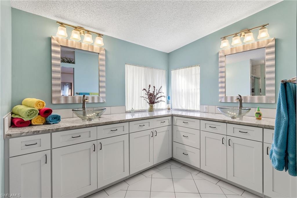 48 Oceans Boulevard, Unit 48 Naples, FL 34104 - Photo 16 of 26 a bathroom with a sink double vanity and a mirror