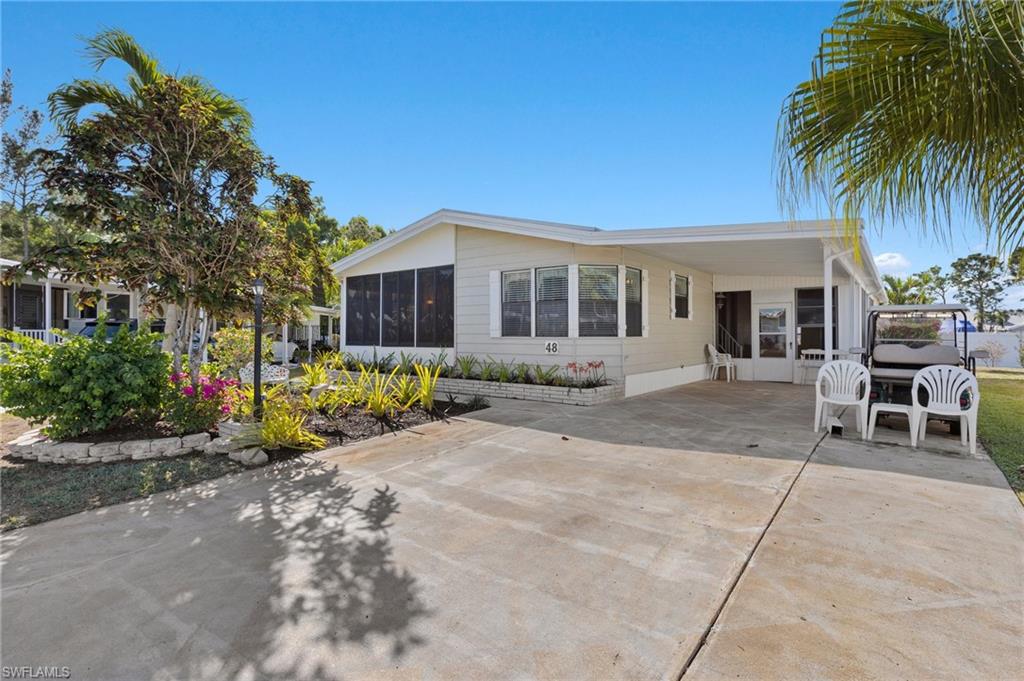 48 Oceans Boulevard, Unit 48 Naples, FL 34104 - Photo 24 of 26 a view of a house with sitting area and garden