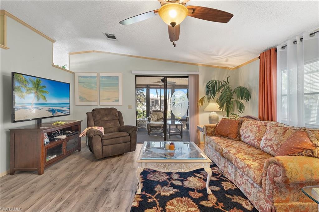 48 Oceans Boulevard, Unit 48 Naples, FL 34104 - Photo 3 of 26 a living room with furniture and a flat screen tv