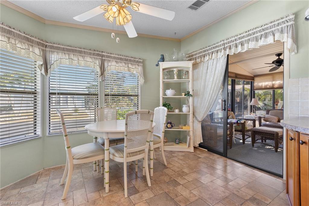 48 Oceans Boulevard, Unit 48 Naples, FL 34104 - Photo 7 of 26 a dining room with furniture a chandelier and window