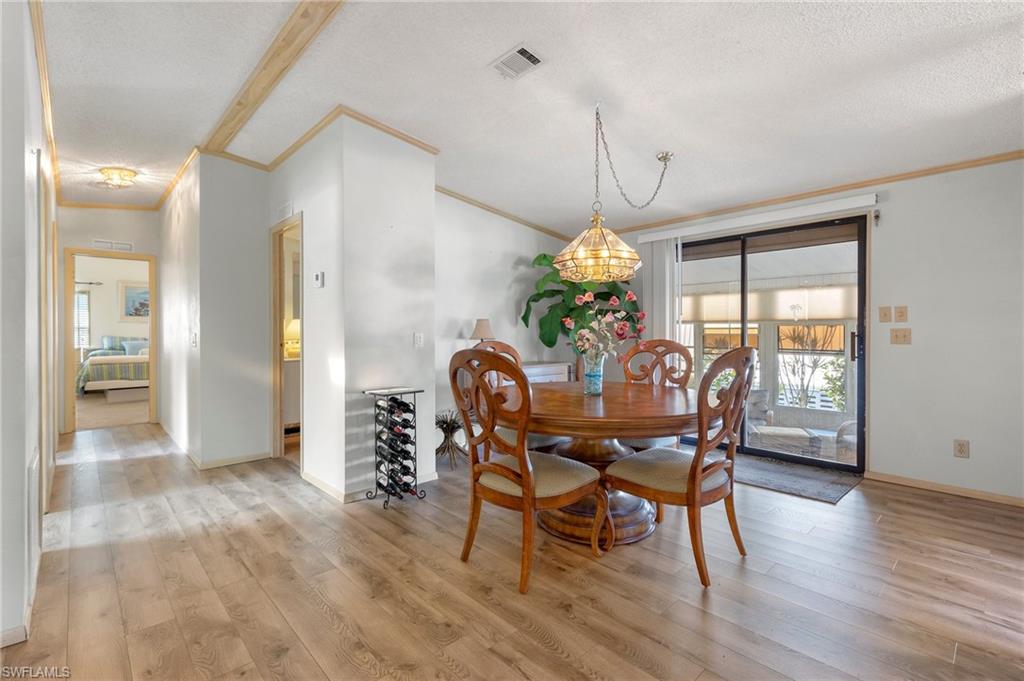 48 Oceans Boulevard, Unit 48 Naples, FL 34104 - Photo 9 of 26 a view of a dining room with furniture window and wooden floor