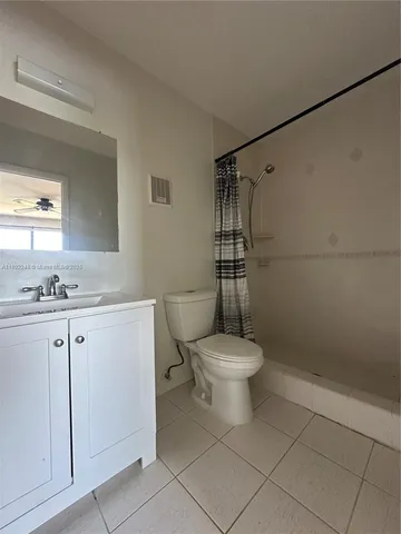 a white toilet sitting next to a bathroom sink