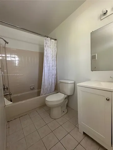 a bathroom with a toilet sink and shower