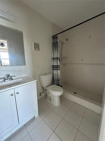a bathroom with a toilet sink and shower