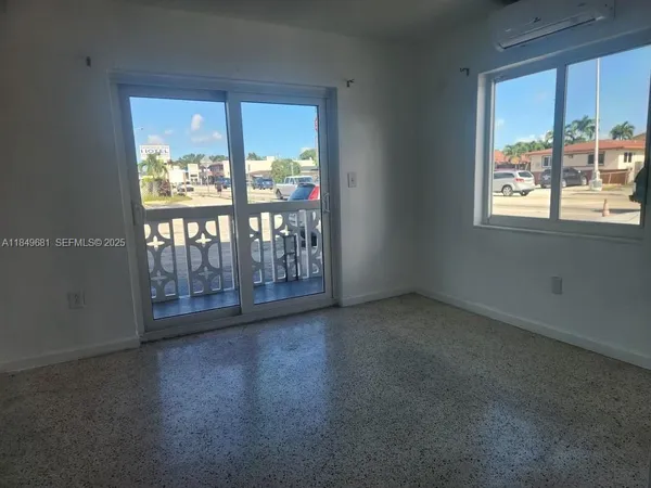 an empty room with windows and closet