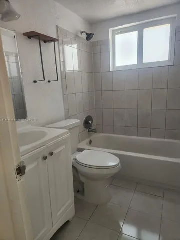 a bathroom with a toilet a sink and bathtub