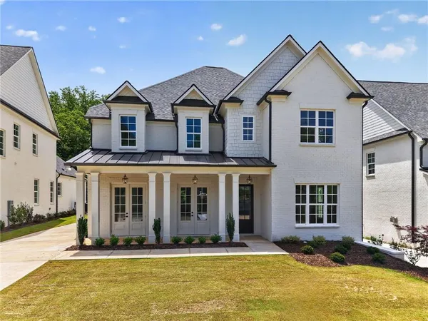 a front view of a house with a yard