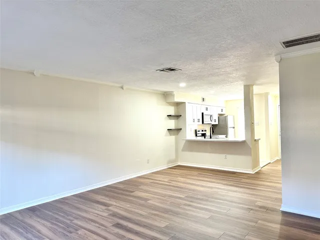 a view of a room with wooden floor