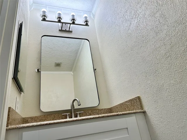 a bathroom with a sink and mirror