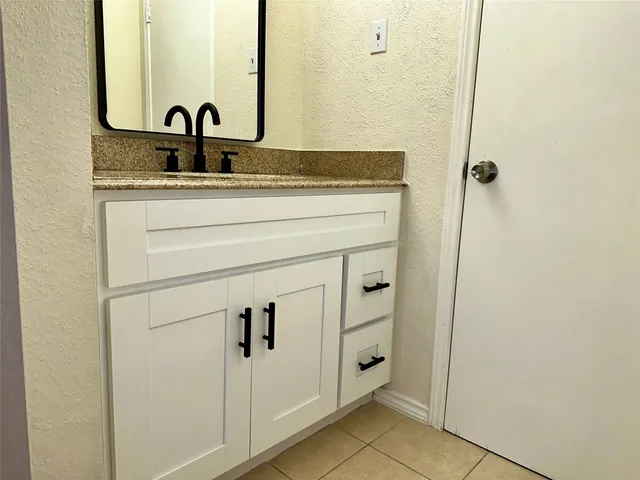 a bathroom with a sink and vanity