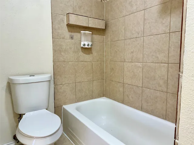 a bathroom with a toilet and shower