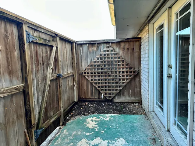 a backyard of a house with wooden fence