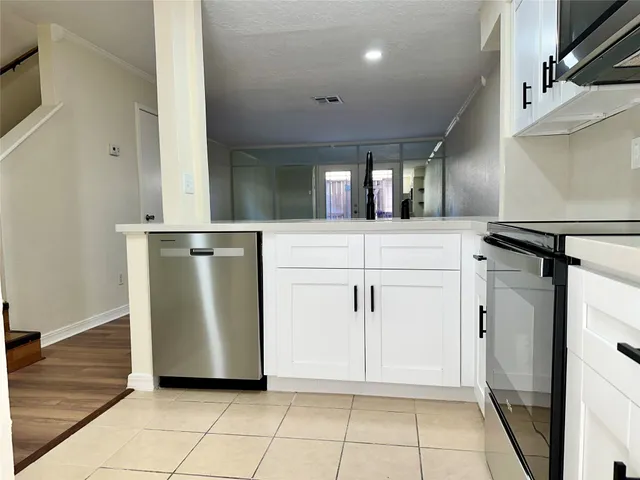 a view of a refrigerator with wooden floor