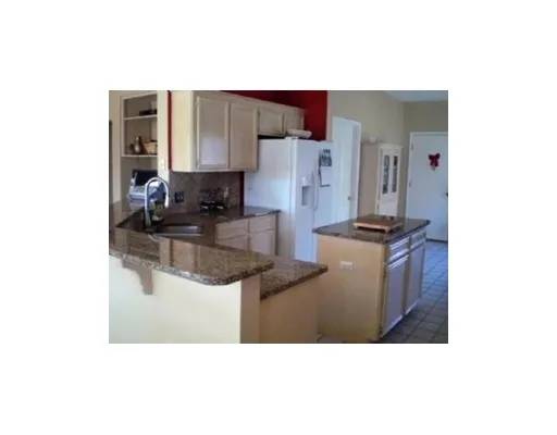 a kitchen with stainless steel appliances kitchen island granite countertop a sink and cabinets