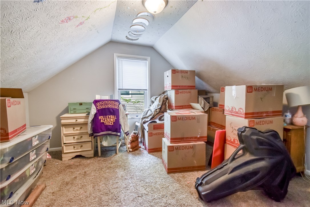 1969 Paisley Road Madison, OH 44057 - Photo 16 of 20 Attic space featuring sloped ceilings, a single window with blinds, and recessed lighting fixtures