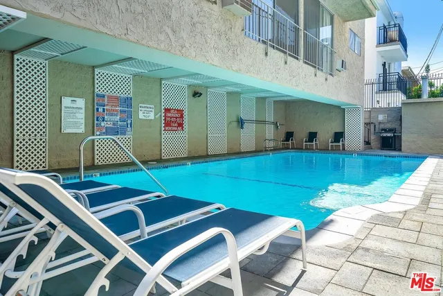 a front view of house with swimming pool outdoor seating