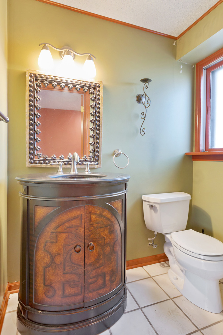 120 Ambleside Road Des Plaines, IL 60016 - Photo 12 of 22 a bathroom with a toilet a sink and mirror
