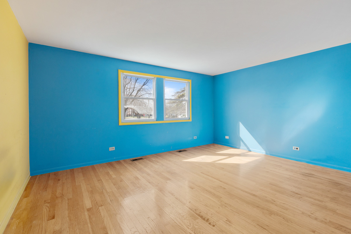 120 Ambleside Road Des Plaines, IL 60016 - Photo 16 of 22 a view of an empty room with window and wooden floor