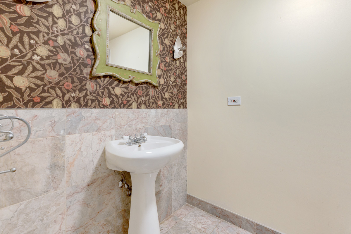 120 Ambleside Road Des Plaines, IL 60016 - Photo 17 of 22 a bathroom with a sink and mirror