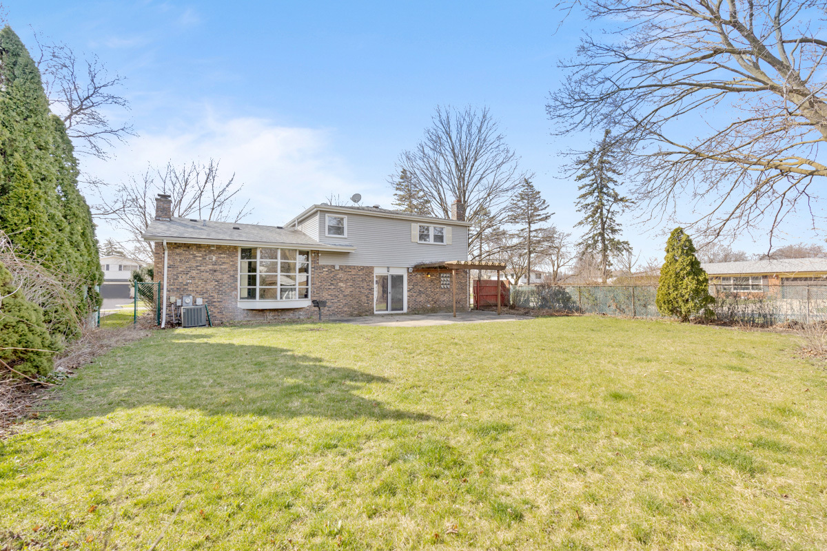 120 Ambleside Road Des Plaines, IL 60016 - Photo 22 of 22 a front view of a house with a yard and garage