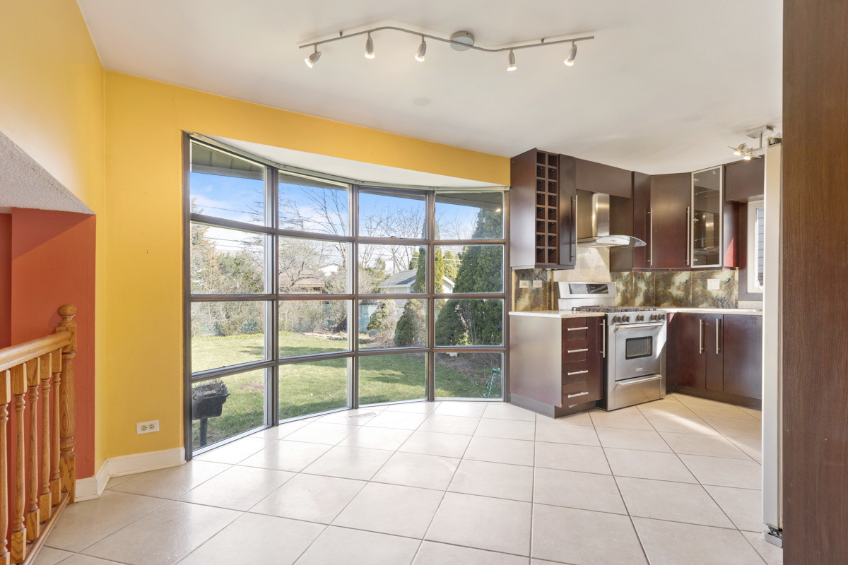 120 Ambleside Road Des Plaines, IL 60016 - Photo 7 of 22 a room with a large window and chandelier