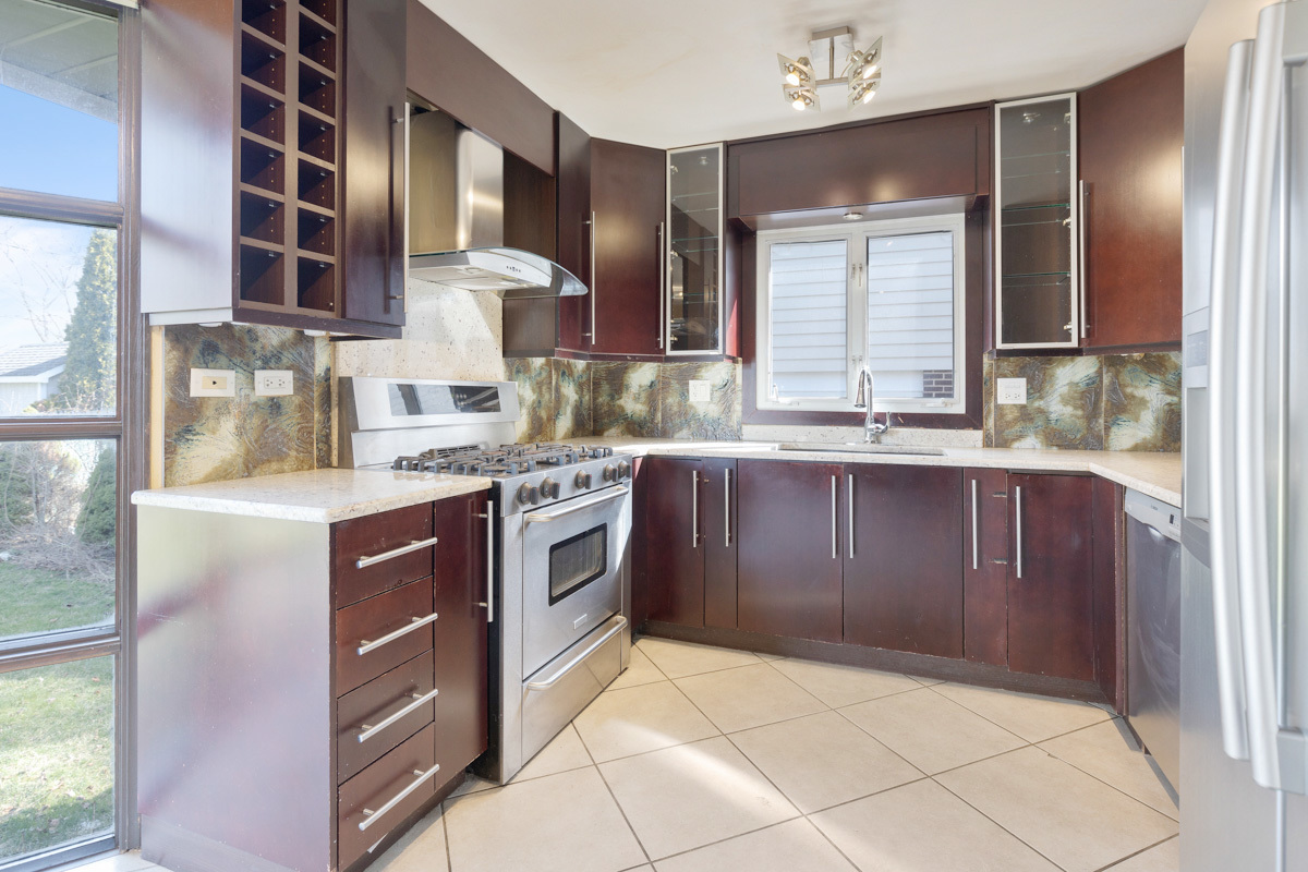 120 Ambleside Road Des Plaines, IL 60016 - Photo 9 of 22 a kitchen with a stove a sink and a microwave