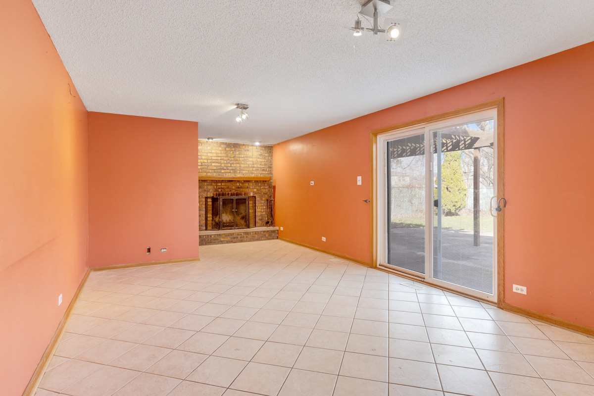 120 Ambleside Road Des Plaines, IL 60016 - Photo 10 of 22 an empty room with fireplace and windows