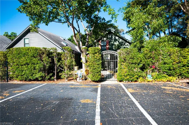 a front view of a house with a yard and a garden