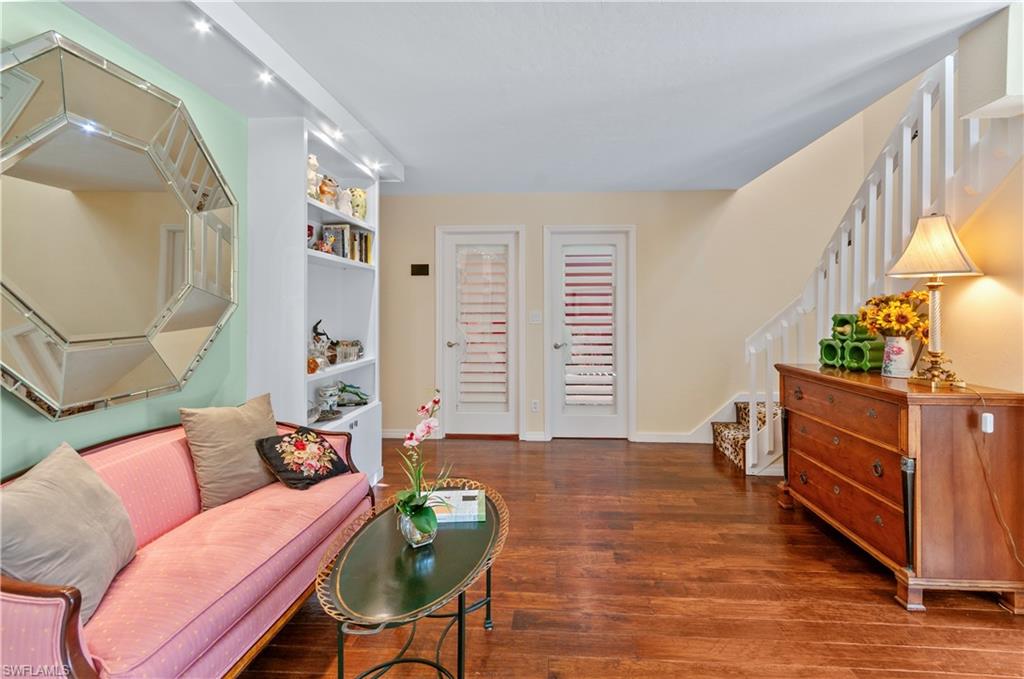 1313 Solana Road, Unit A3 Naples, FL 34103 - Photo 16 of 29 Living area featuring stairs and dark wood-style floors