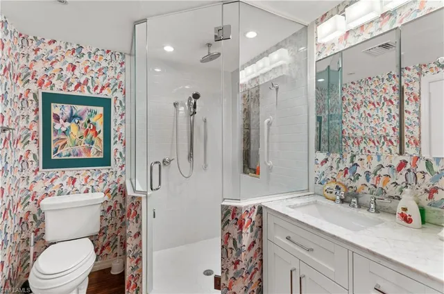 a bathroom with a sink toilet and shower