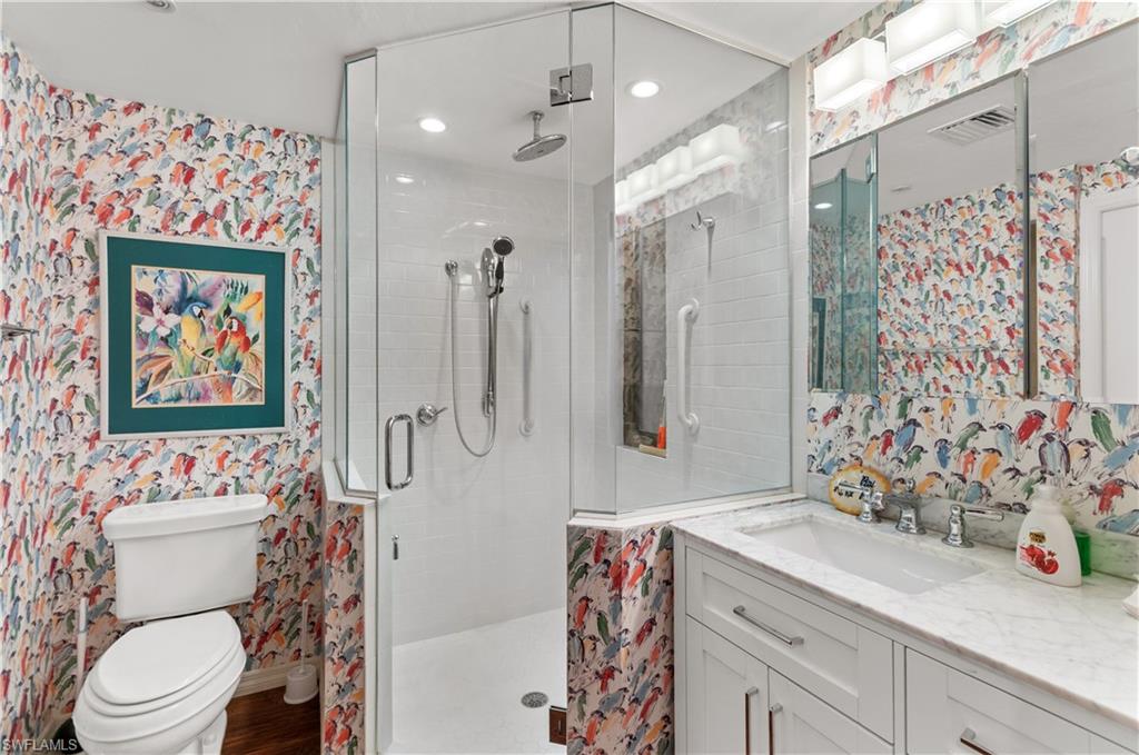 1313 Solana Road, Unit A3 Naples, FL 34103 - Photo 19 of 29 Full bathroom featuring wallpapered walls, birds . vanity, and a shower stall
