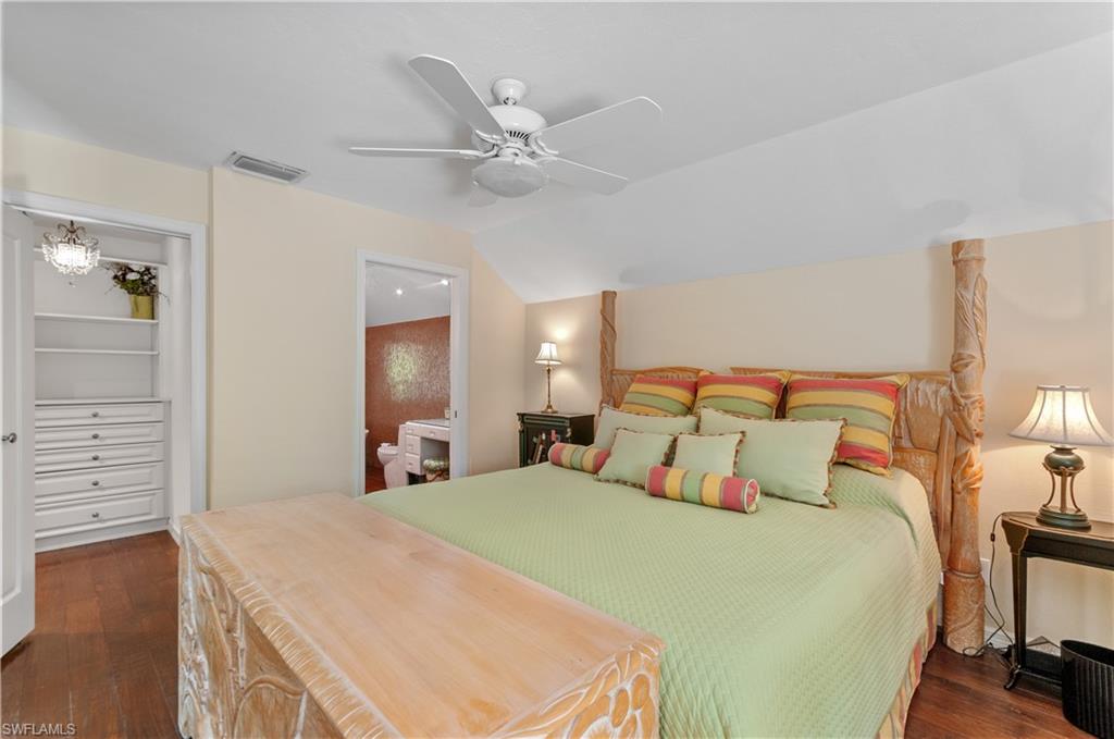 1313 Solana Road, Unit A3 Naples, FL 34103 - Photo 20 of 29 2nd floor main Bedroom featuring vaulted ceiling, ceiling fan, dark wood-style floors, and ensuite bathroom and many built in-storage