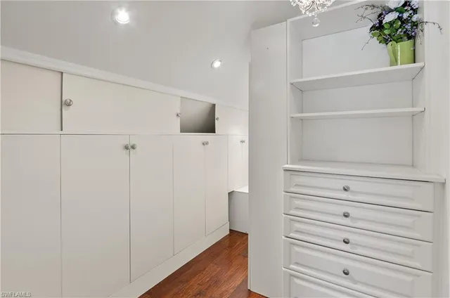 a view of walk in closet with empty racks